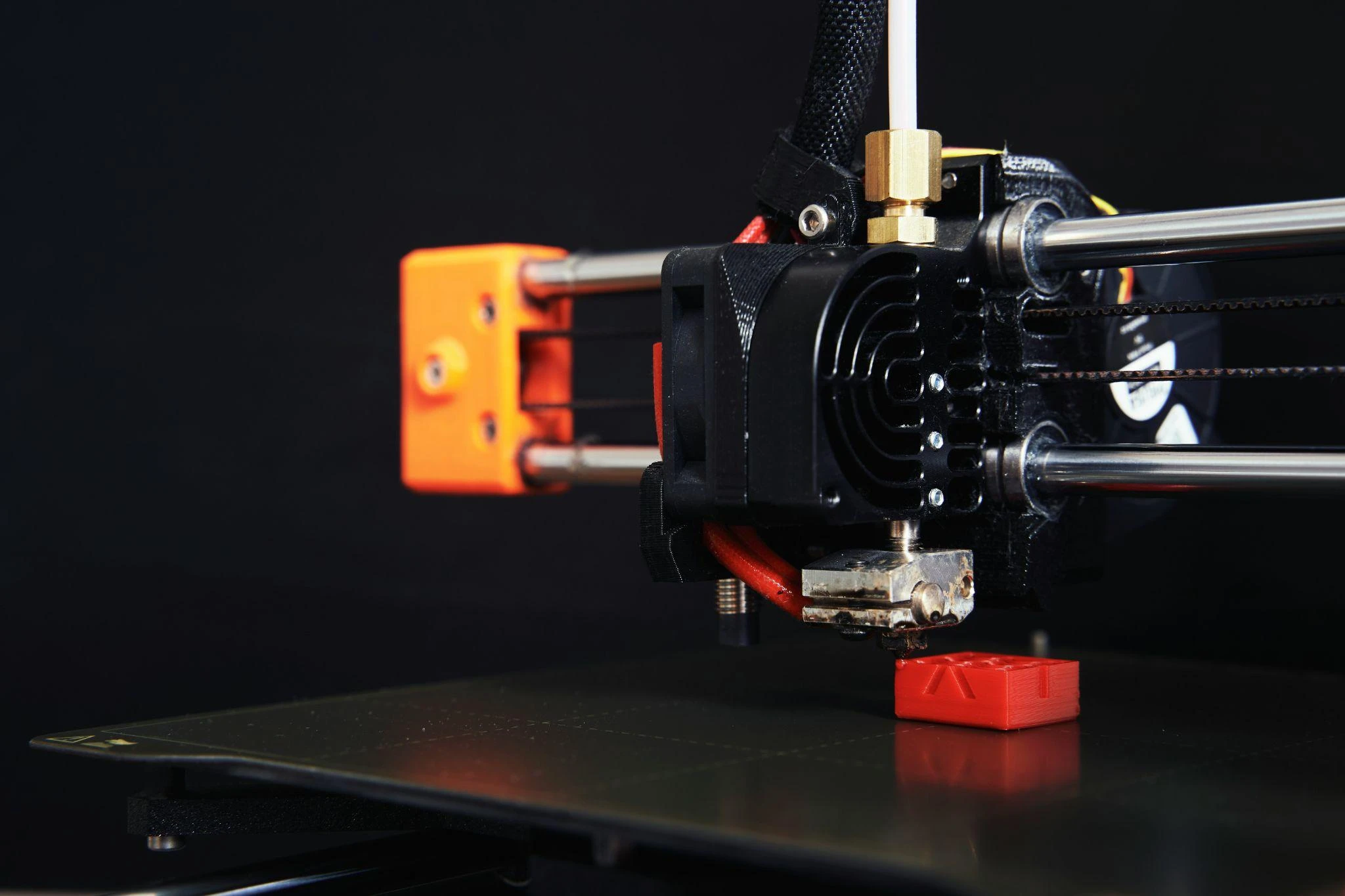 3d printer printing a red block